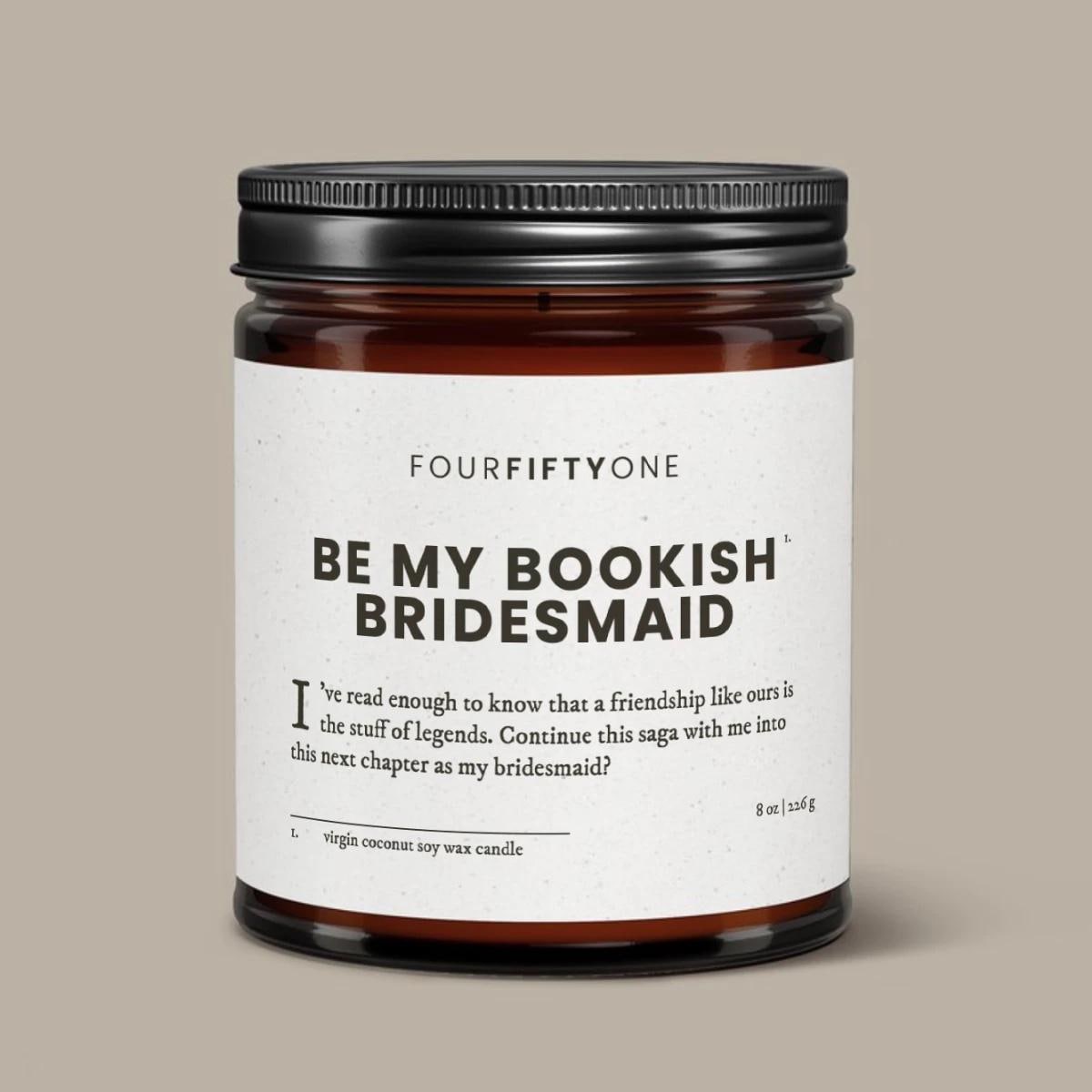 Be My Bookish Bridesmaid proposal soy candle in an amber glass jar with a black lid, cream label with FOURFIFTYONE branding.